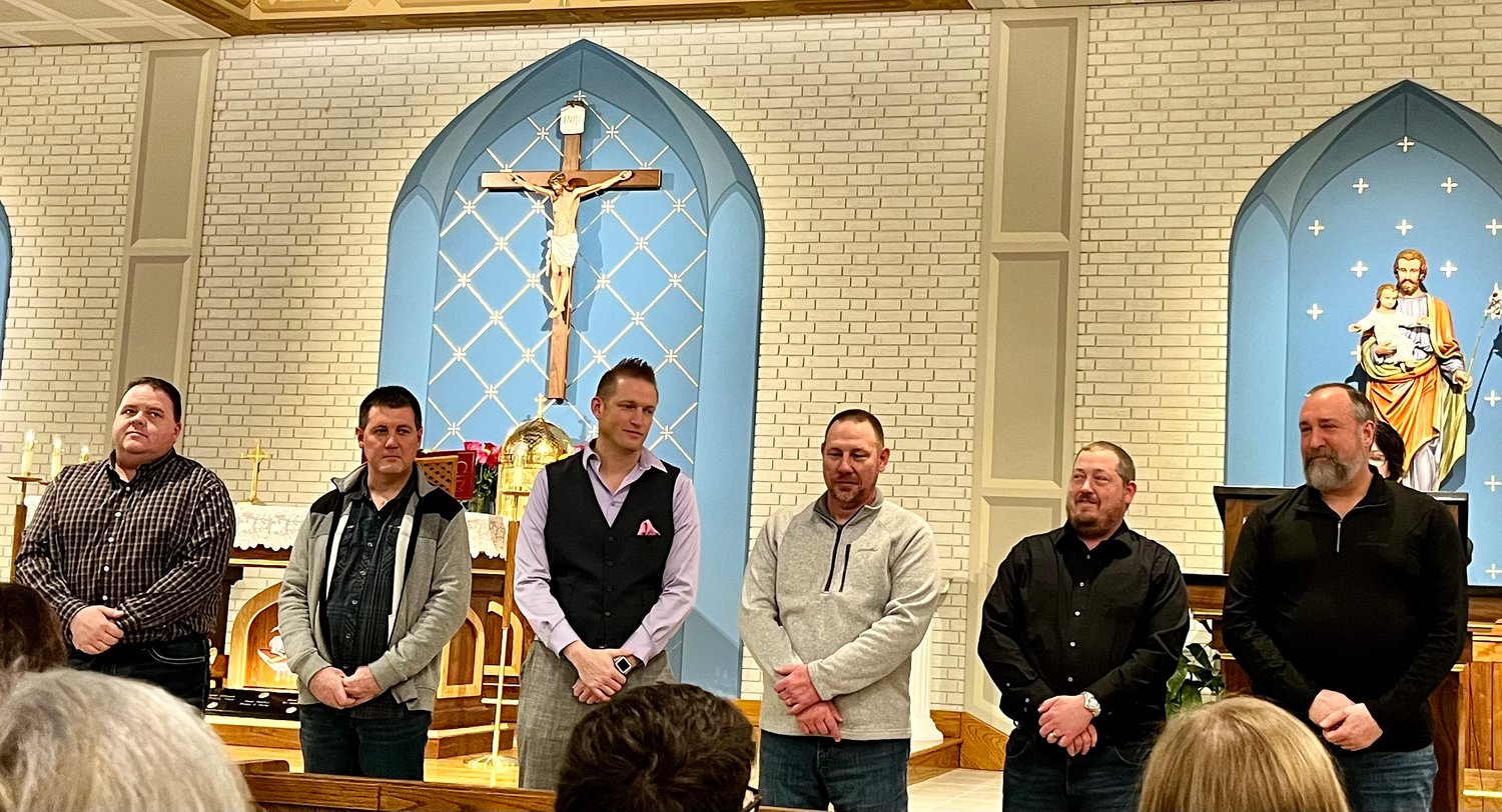 Scott Wingrath, Chris Jurd, Neil Loethen, Kevin Grellner, Sam Reinkemeyer and Terry Johnson, who are all married to teachers at St. George School in Linn, were honored with Distinguished Graduate Awards from the school during Catholic Schools Week.